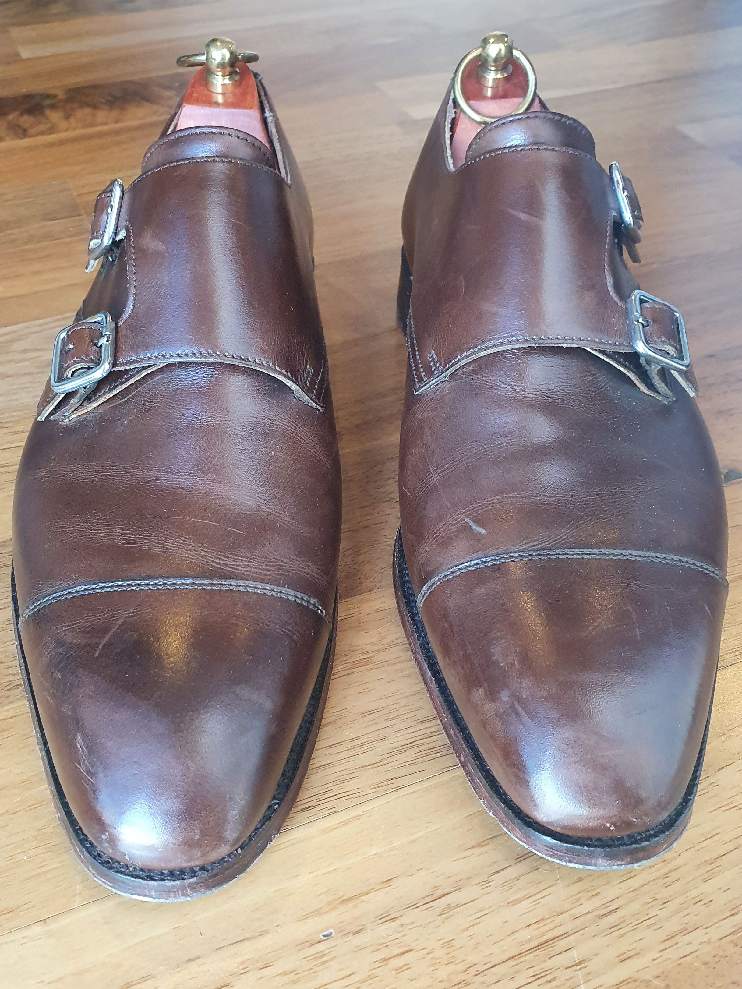 Scuffed pair of brown Crockett & Jones double monk shoes